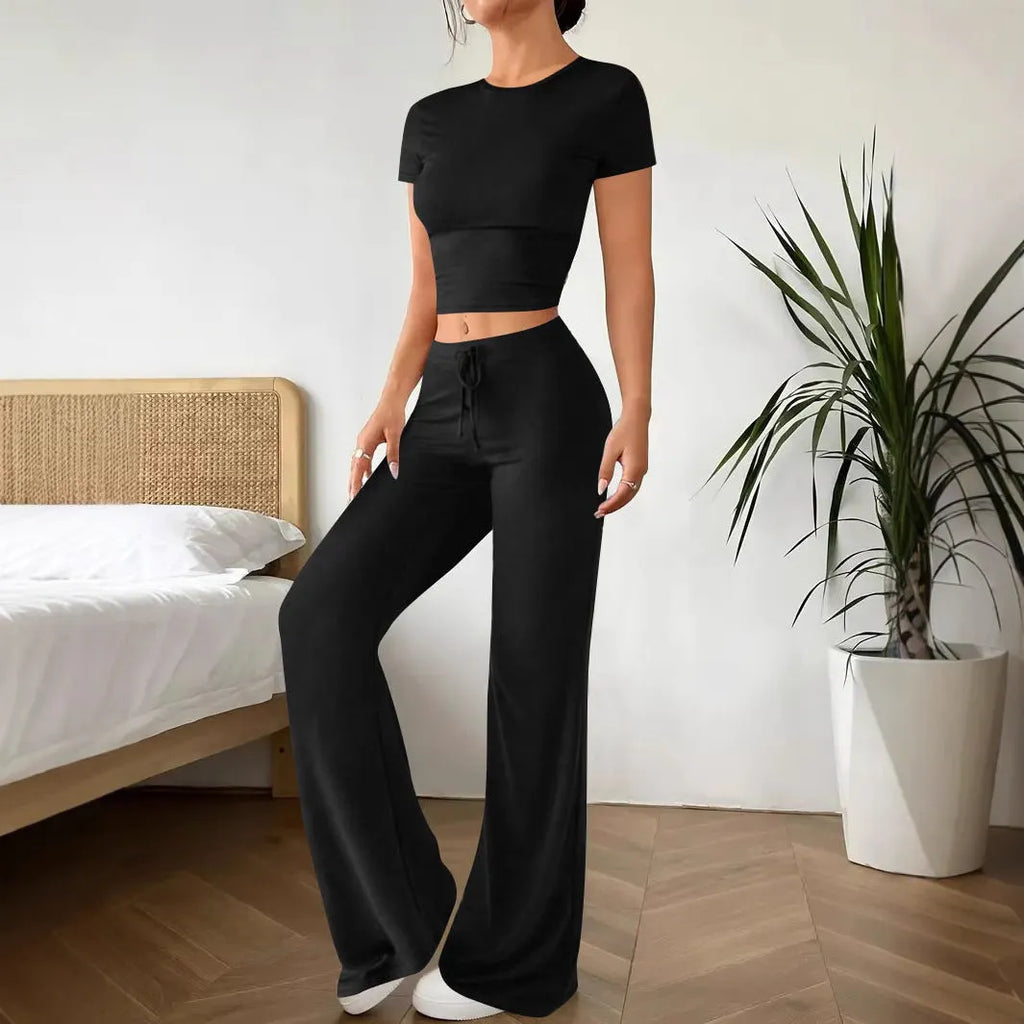 Black high waist trousers and short sleeve t-shirt matching set laid flat showing coordinated outfit
