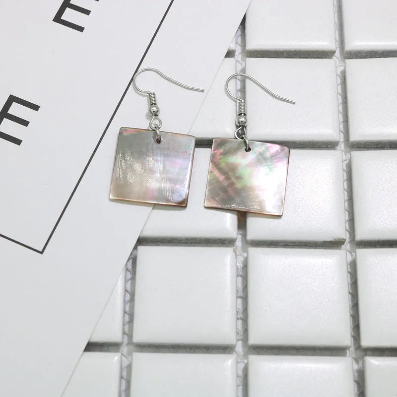 Women's geometric shell earrings with rectangular or square panther designs in natural colours