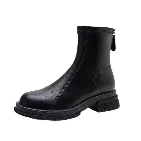 Women's black flat heel ankle boots with a back zipper and round toe, shown on a foot.