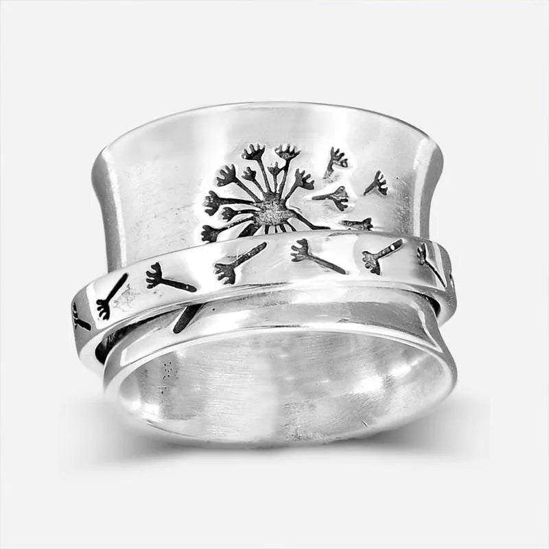 Silver colour rotatable flower ring on finger showing floral centrepiece
