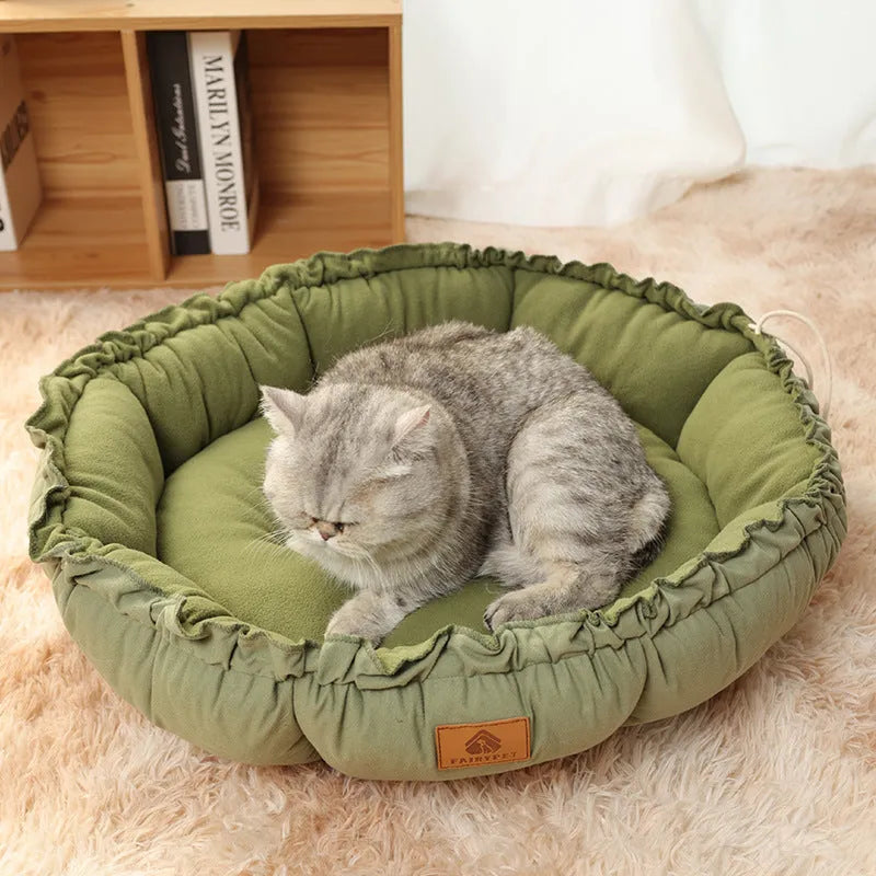 Grey reversible donut cat bed showing sherpa and velvet sides, suitable for indoor cats.