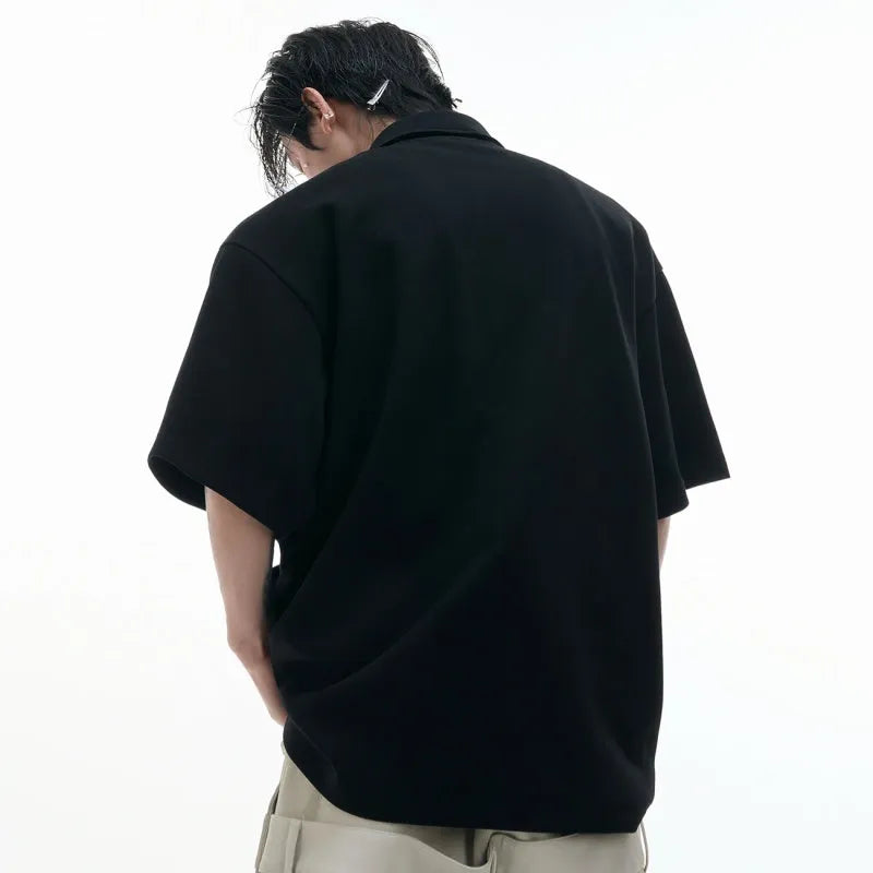 Men's loose fit deconstructed polo shirt with geometric print in black, gray, or white.
