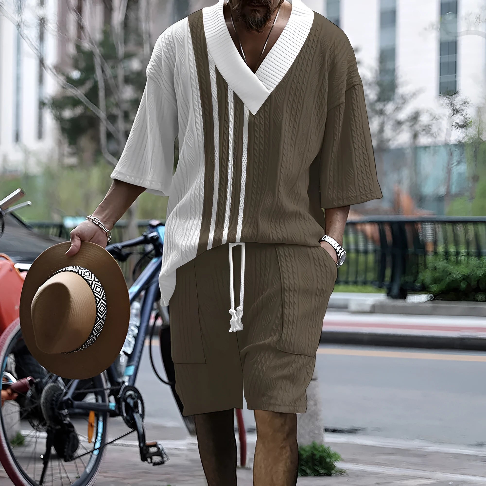 Printed men's knitted drop-shoulder short-sleeved top and matching shorts set in a polyester blend.