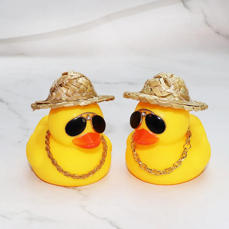 Straw hat yellow duck car dashboard ornament with removable sunglasses necklace on adhesive base.