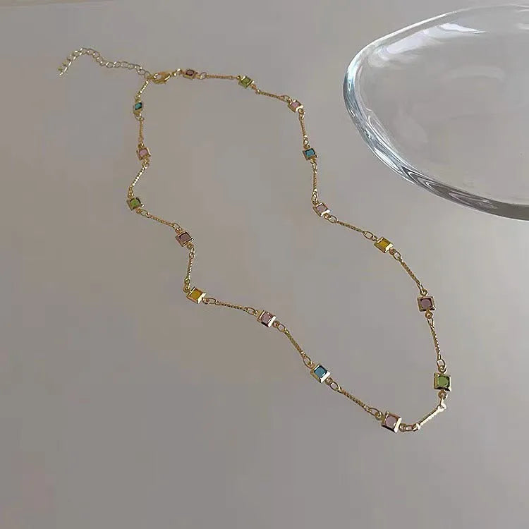 Square geometry clavicle chain necklace with artificial crystal and quadrilateral elements in gold finish