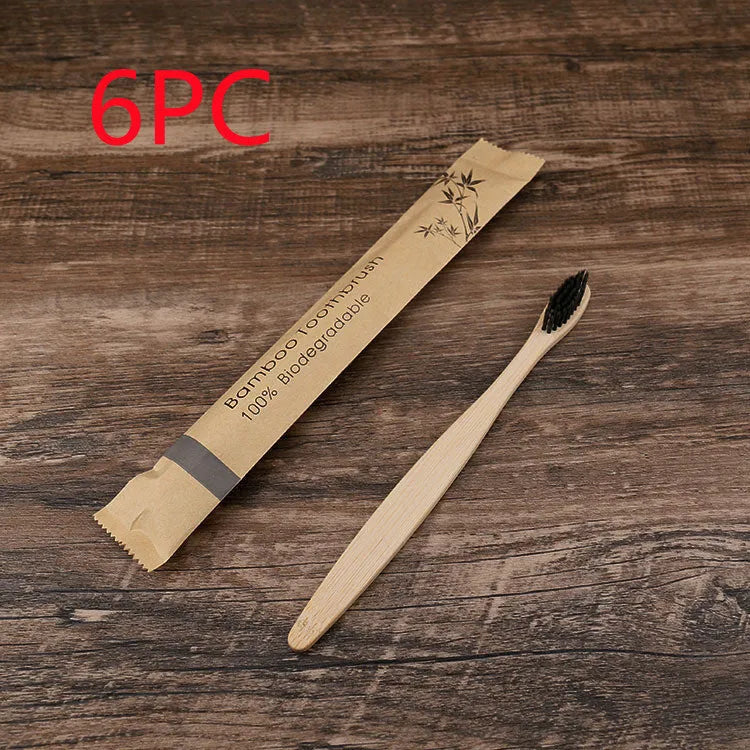 Set of ten bamboo toothbrushes with charcoal-infused bristles in assorted colours on a white background.