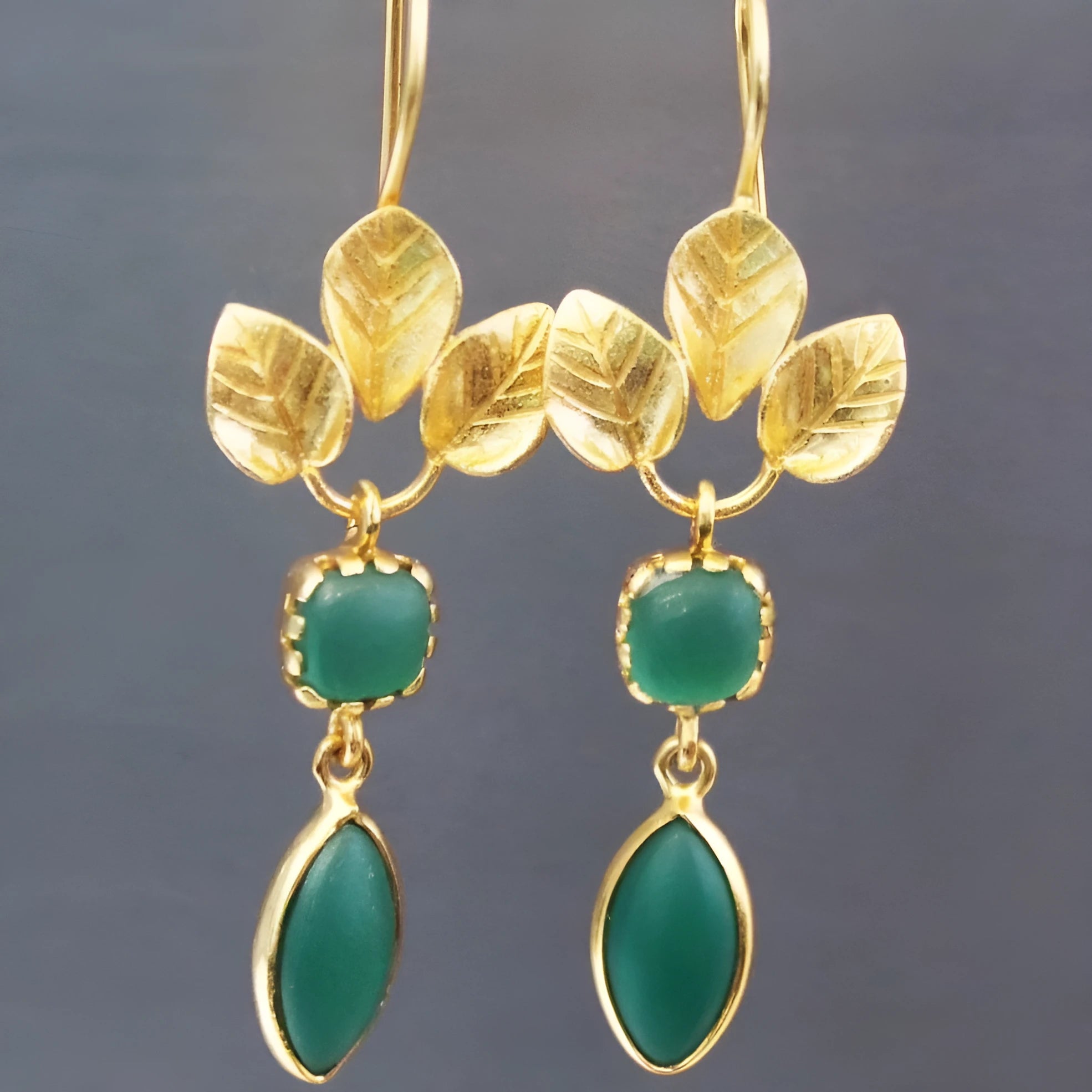 Gold-coloured delicate drop earrings with French leaves, tassels, and zircon accents in water droplet shape