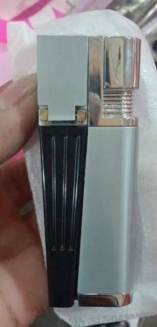 Silver foldable metal pipe lighter shown open, revealing the lighter mechanism and a small stash compartment.