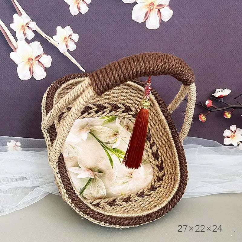 Small hand-woven straw basket in coffee brown colour on a wooden table.