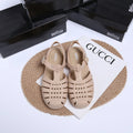 Matte black Roman sandals with vintage weave pattern and buckle closure