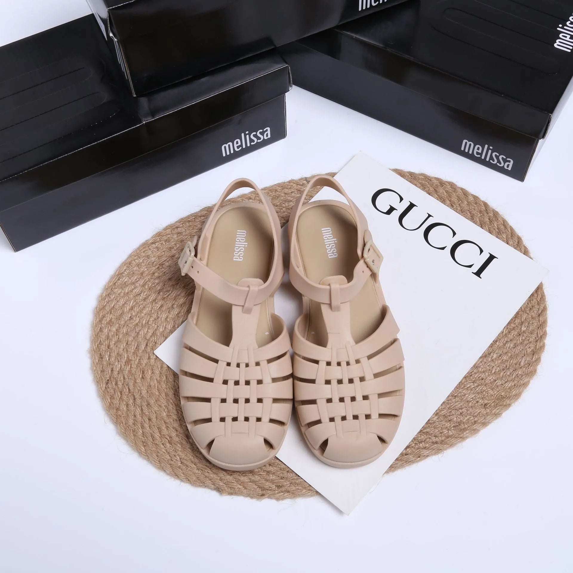 Matte black Roman sandals with vintage weave pattern and buckle closure