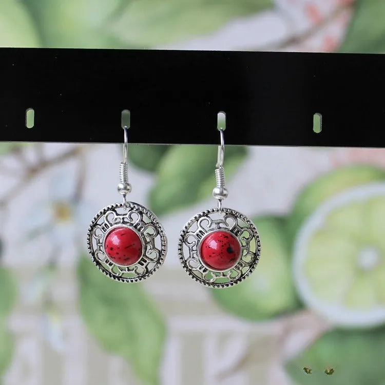 Handmade geometric flower disk earrings in Tibetan silver and turquoise with auspicious cloud patterns.