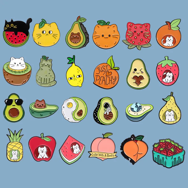 Colourful cartoon fruit design metal brooch with pin back on a fabric background.