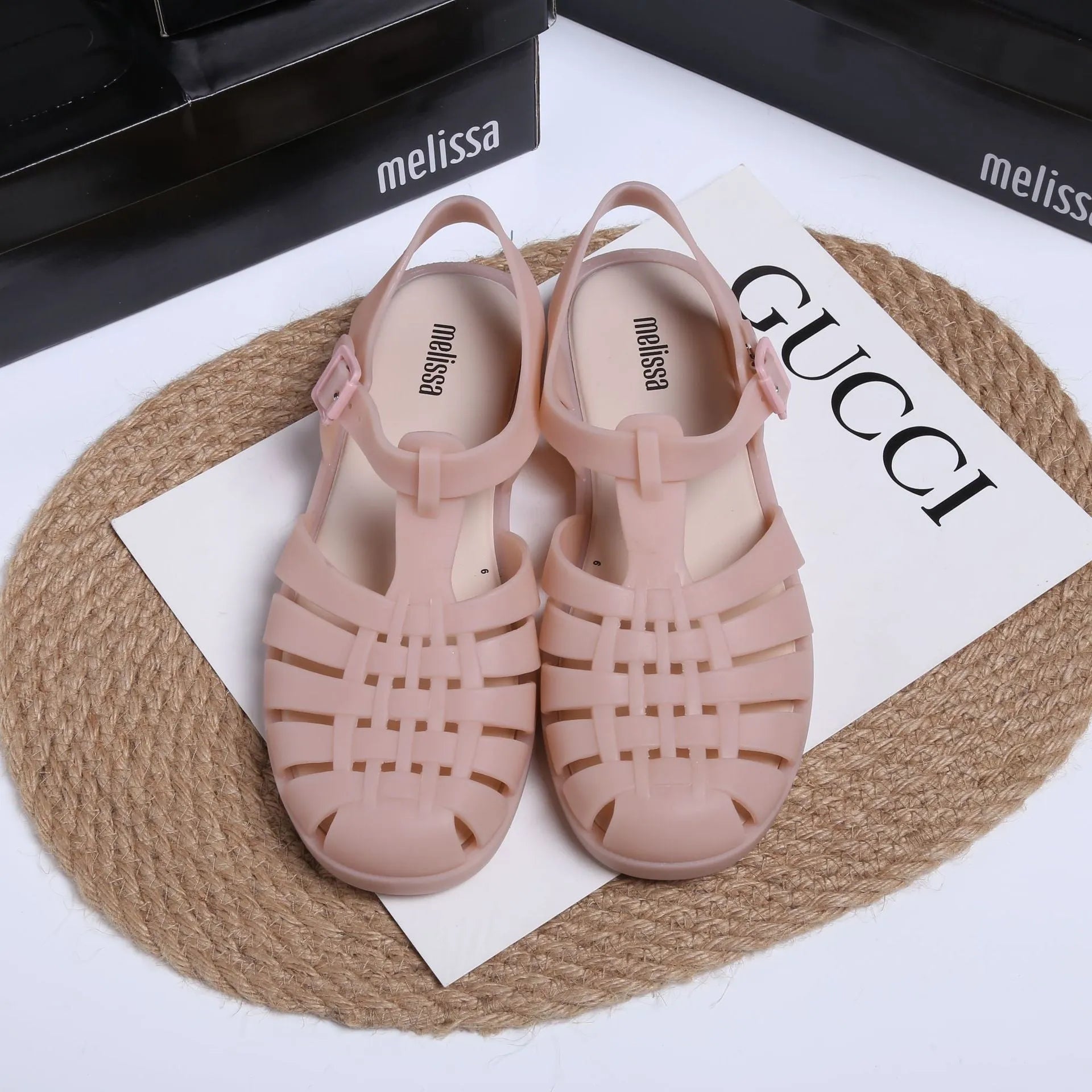 Matte black Roman sandals with vintage weave pattern and buckle closure