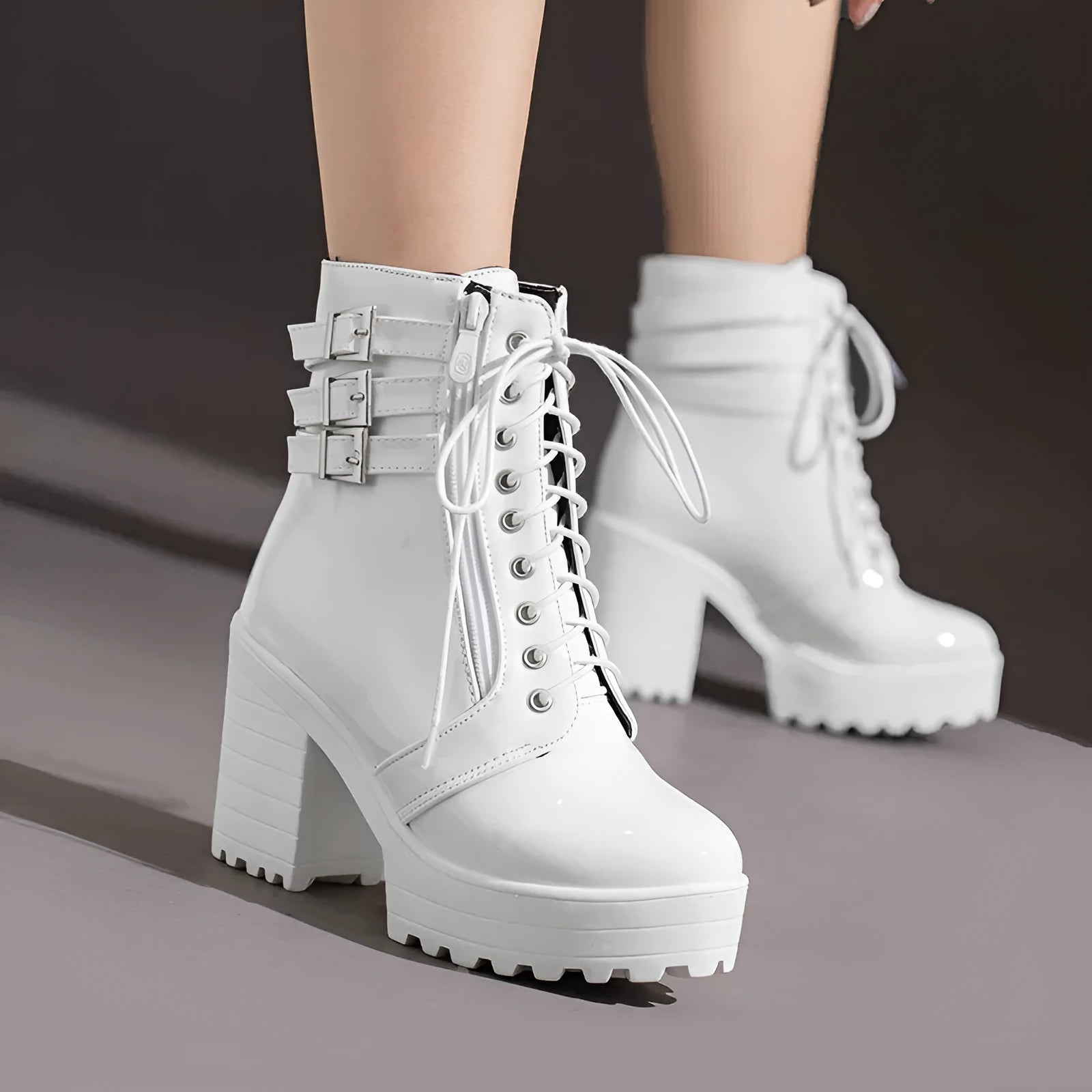 Women's black thick-heel ankle boots with round toe and front lace-up design.