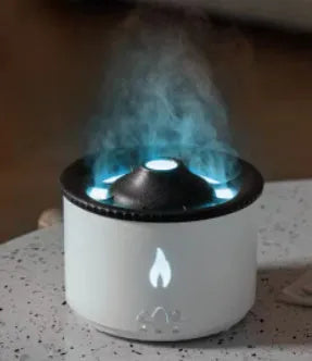 Round two-colour flame spray mist humidifier and aromatherapy diffuser on a table.