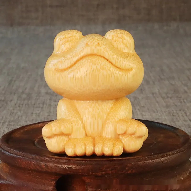 Solid bamboo carving ornament of smiling frog design measuring 5cm height and 4.5cm diameter