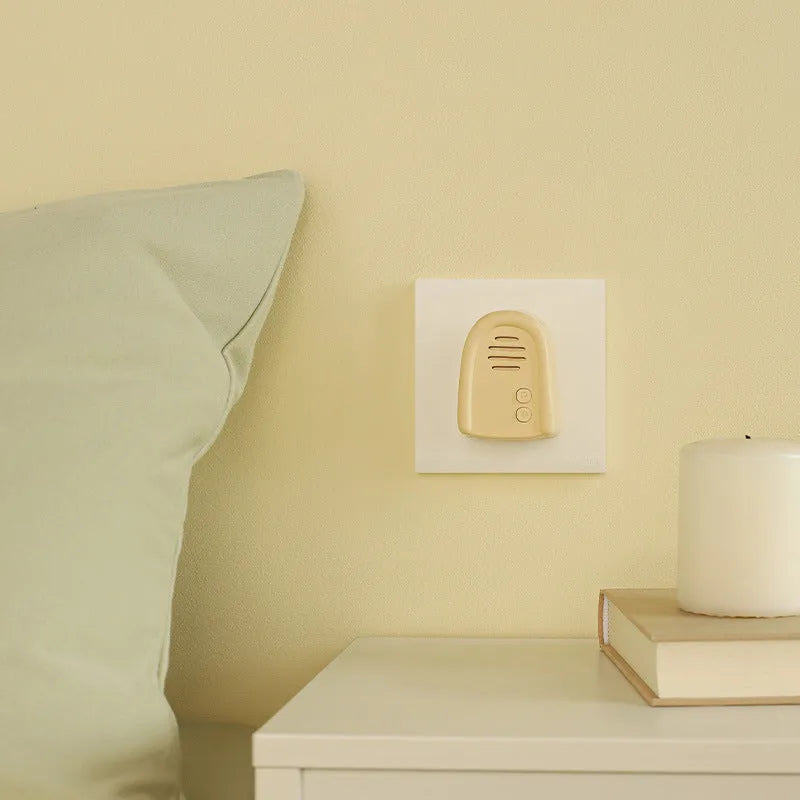 Wireless plug-in doorbell in milky yellow or white for household entryway use
