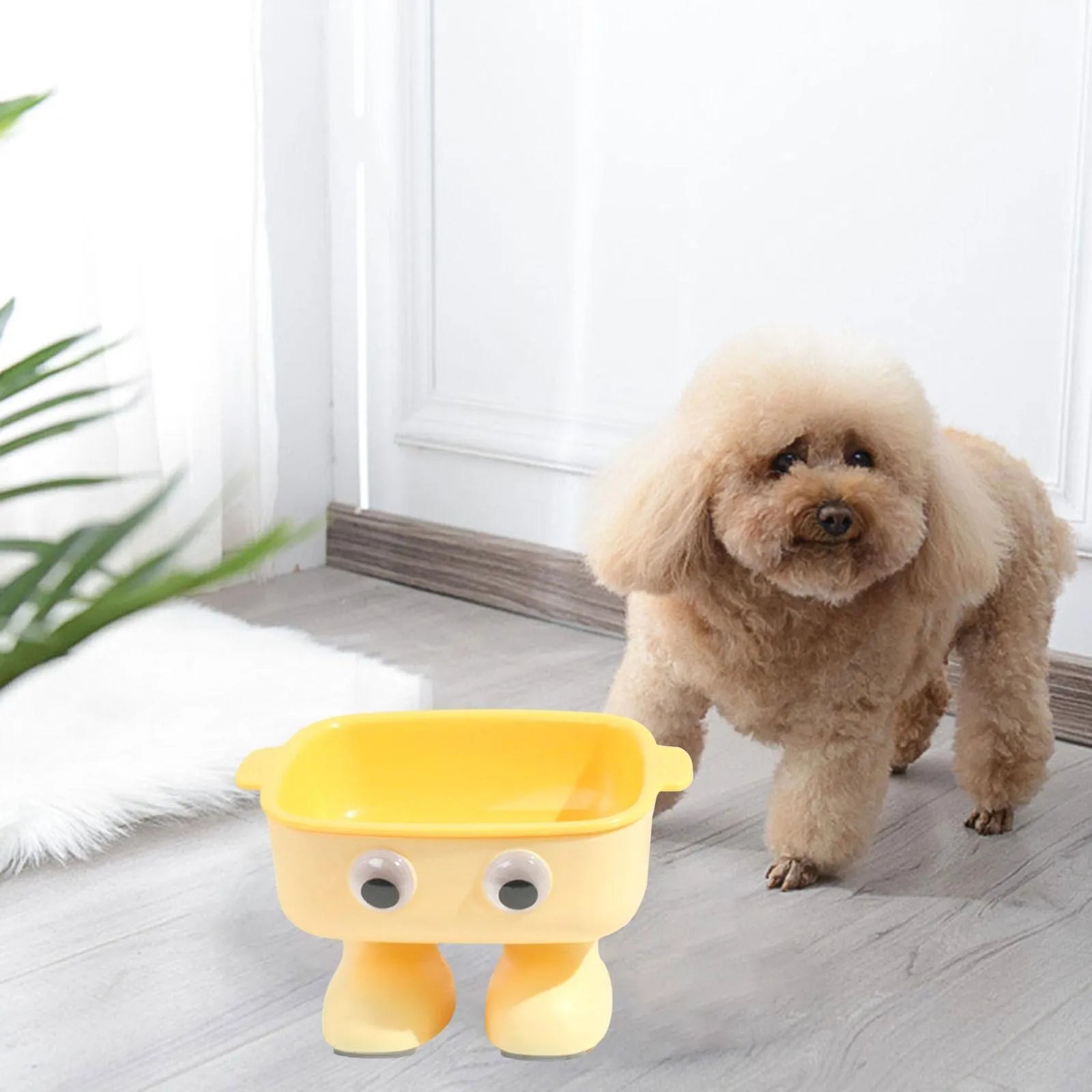 Green robot-shaped elevated cat bowl with tilted food dish and non-slip base.