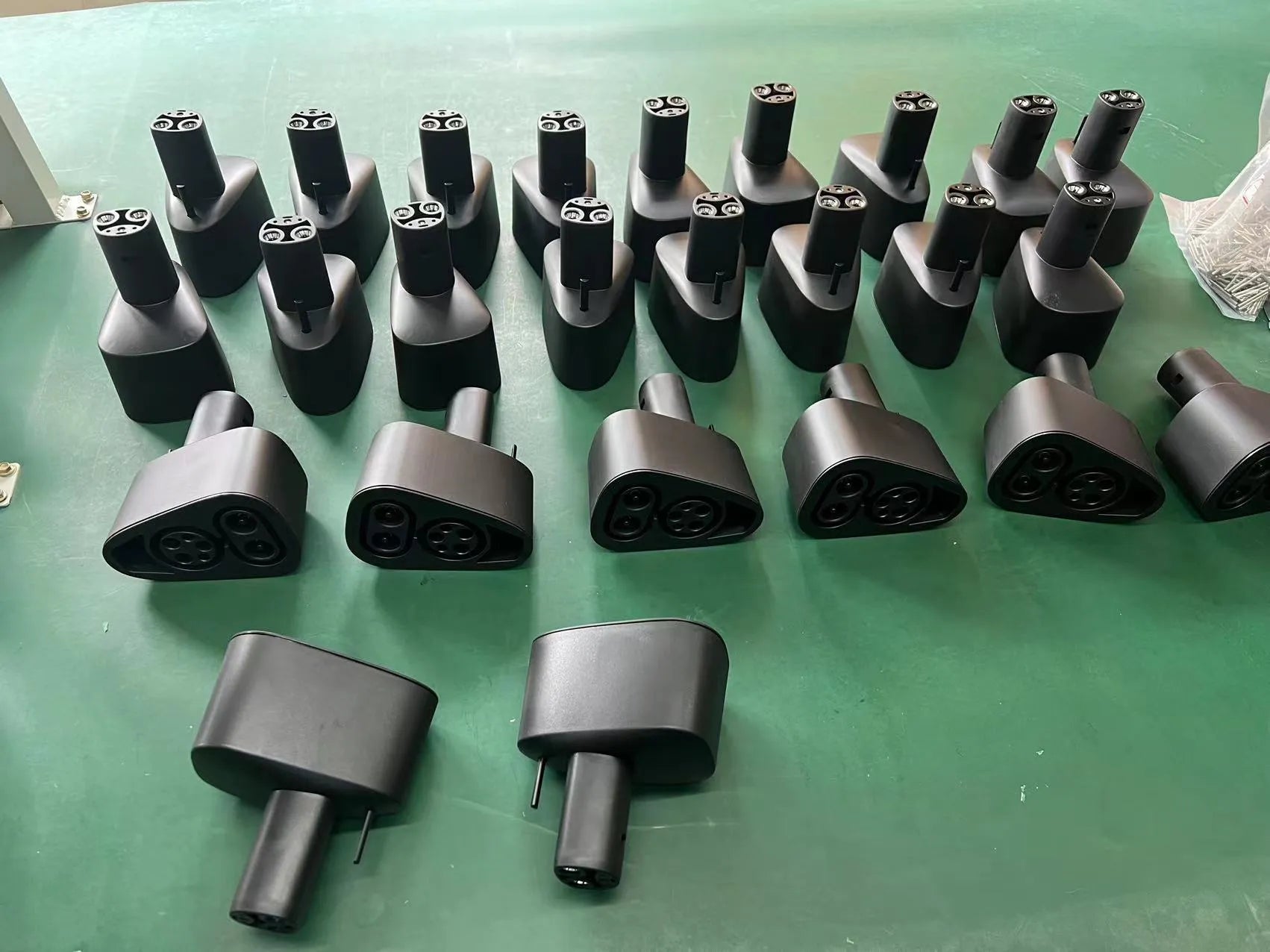 Black Tesla charging plug conversion adapter showing connection pins and dustproof housing