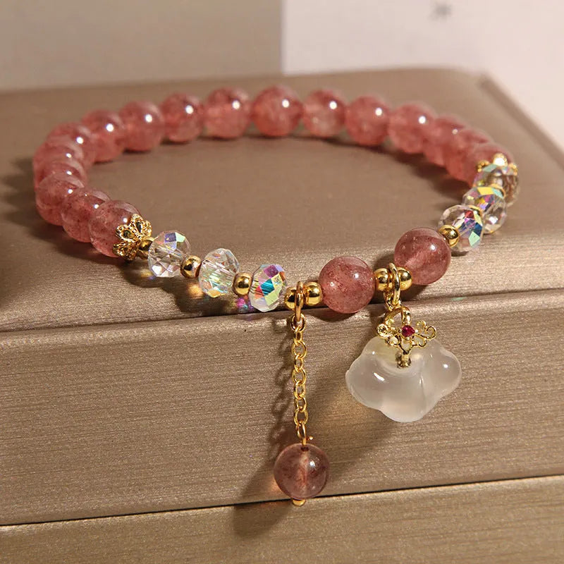 Women's adjustable crystal bracelet with strawberry quartz and white agate beads showing adjustable chain detail