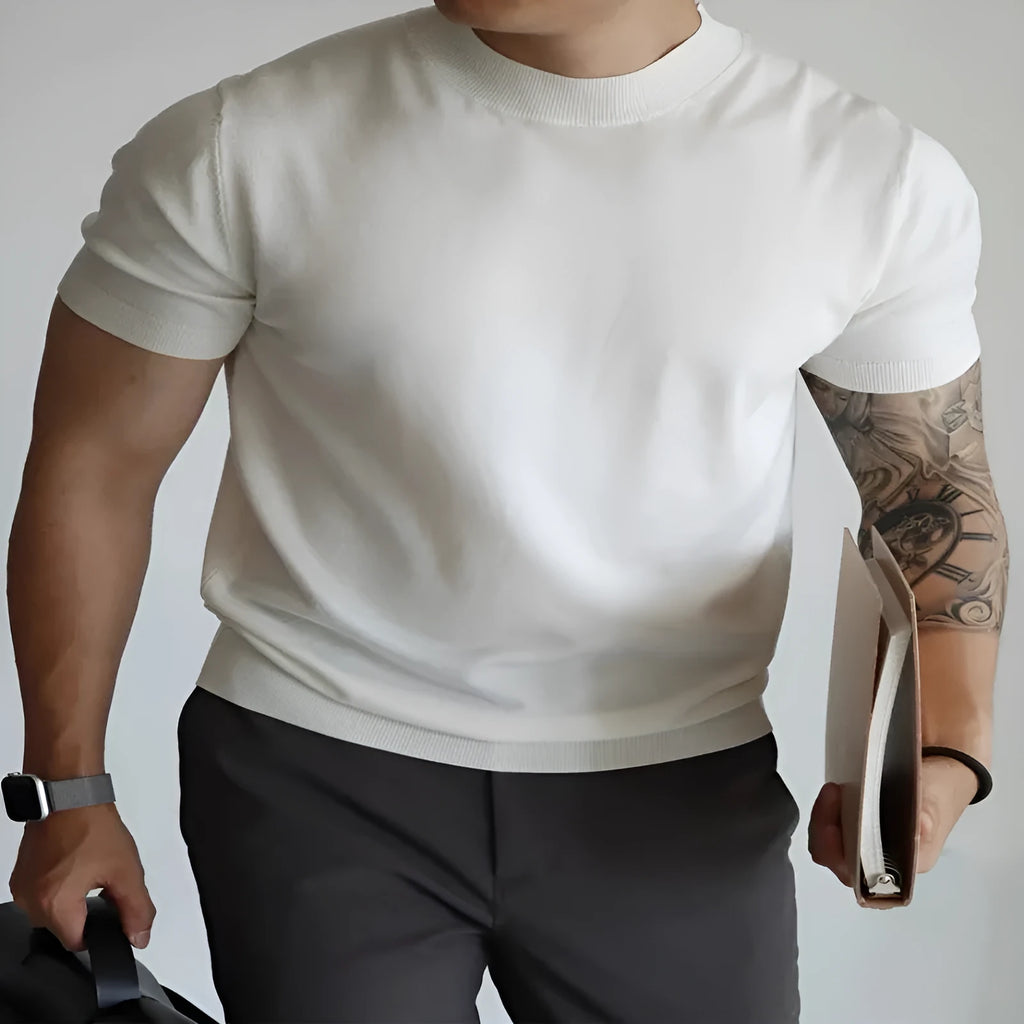 Man wearing a slim-fit solid colour polyester t-shirt, showcasing its lightweight knitwear construction.
