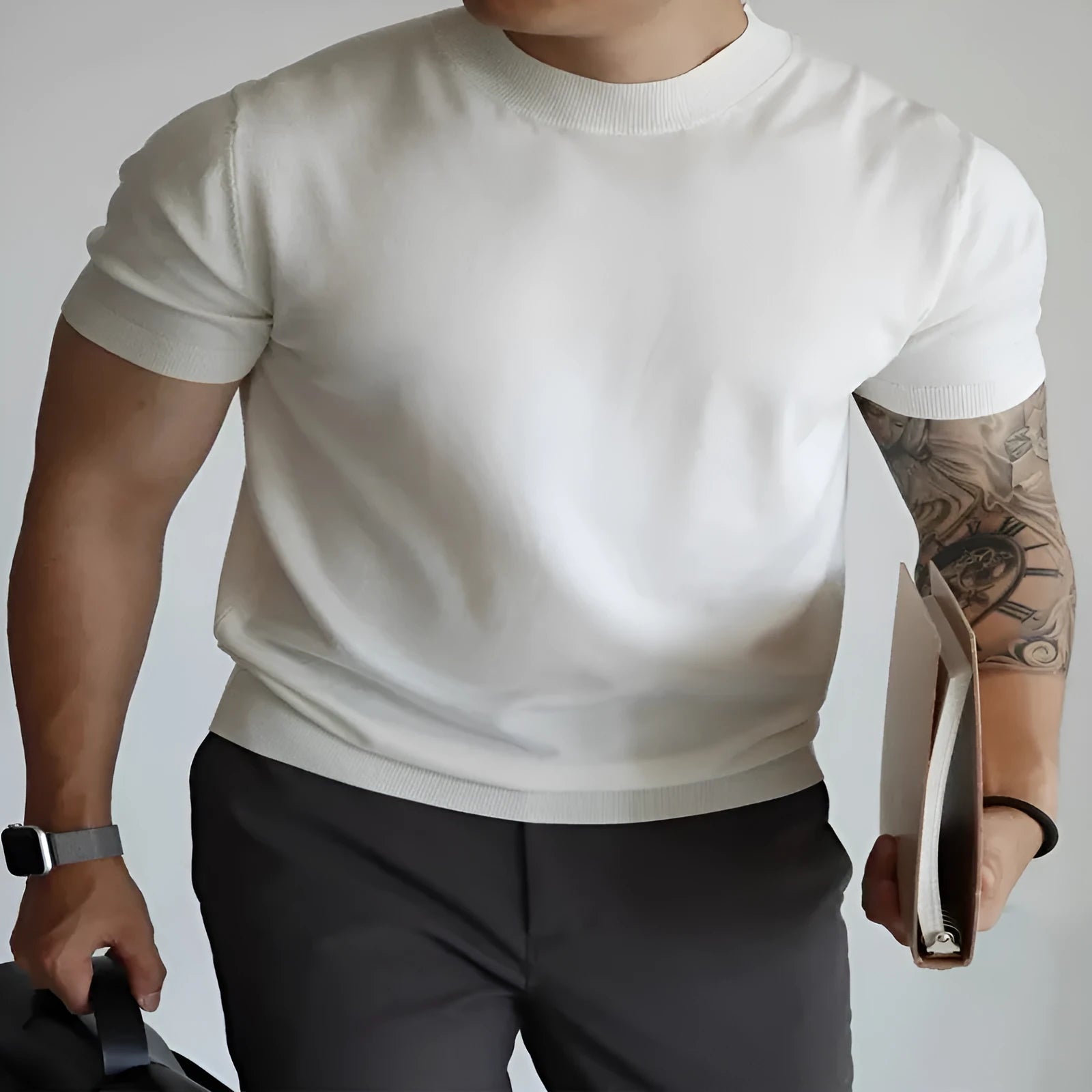 Man wearing a slim-fit solid colour polyester t-shirt, showcasing its lightweight knitwear construction.