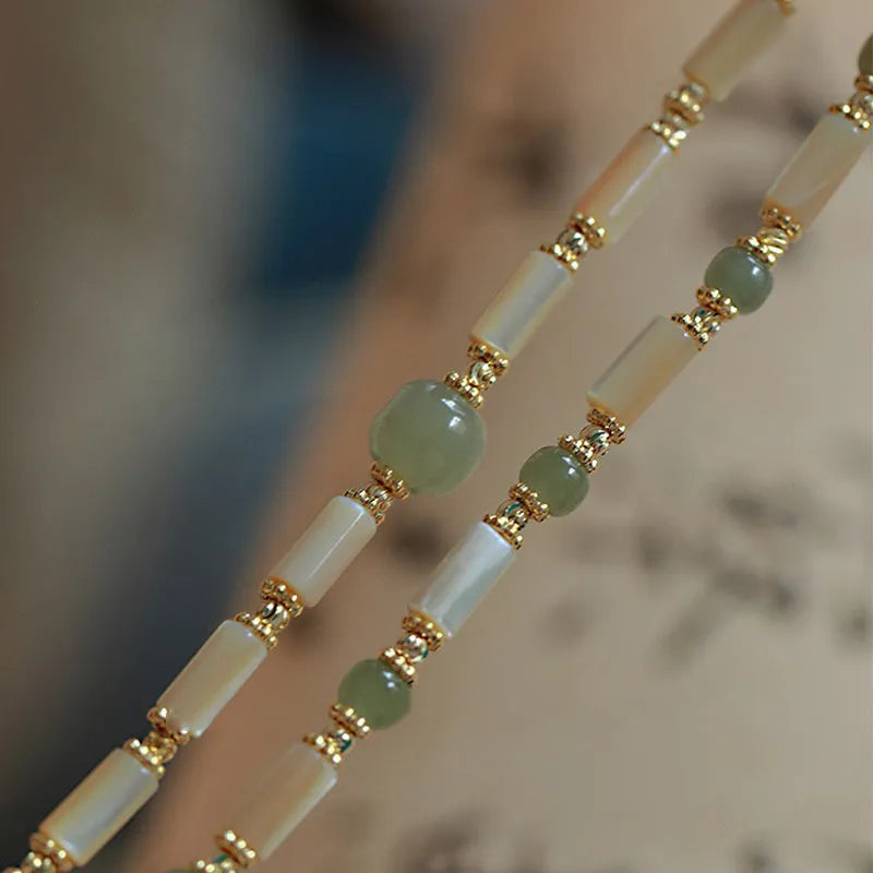 Hetian jade white lip shell bracelet with geometric round design on wrist
