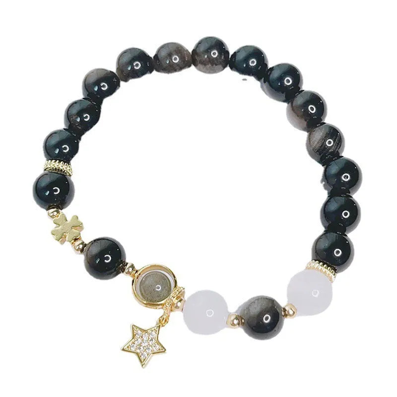 Adjustable silver stone bracelet for women with choice of flower, love, or star charm on a white background.