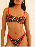 Women's cherry print tube top bikini swimsuit in brief style on a mannequin.