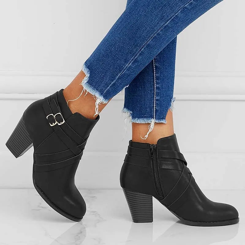 Women's grey PU leather ankle boot with a 7cm heel, side zipper, and belt buckle.