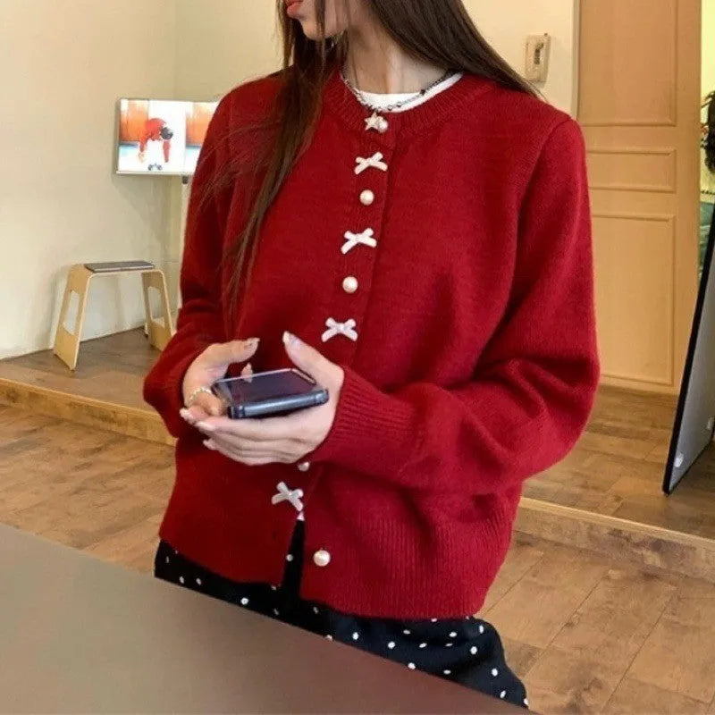 Women's solid colour cardigan sweater with pearl buttons in light blue.