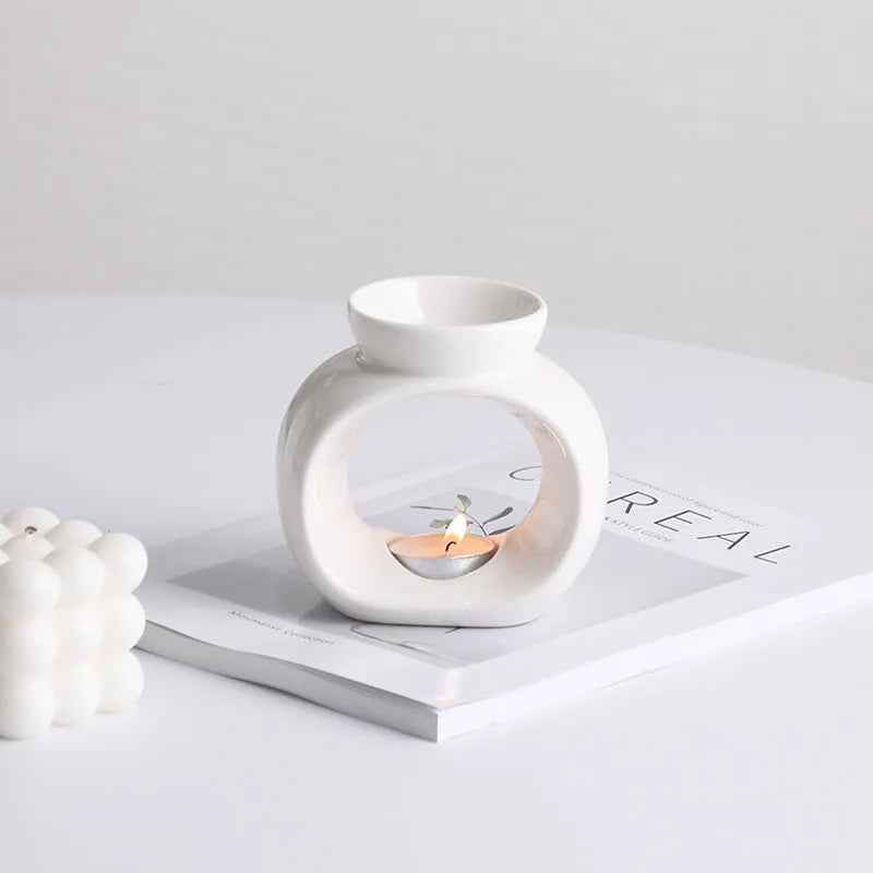 White Nordic minimalist ceramic aromatherapy stove ornament for indoor fragrance diffusion.