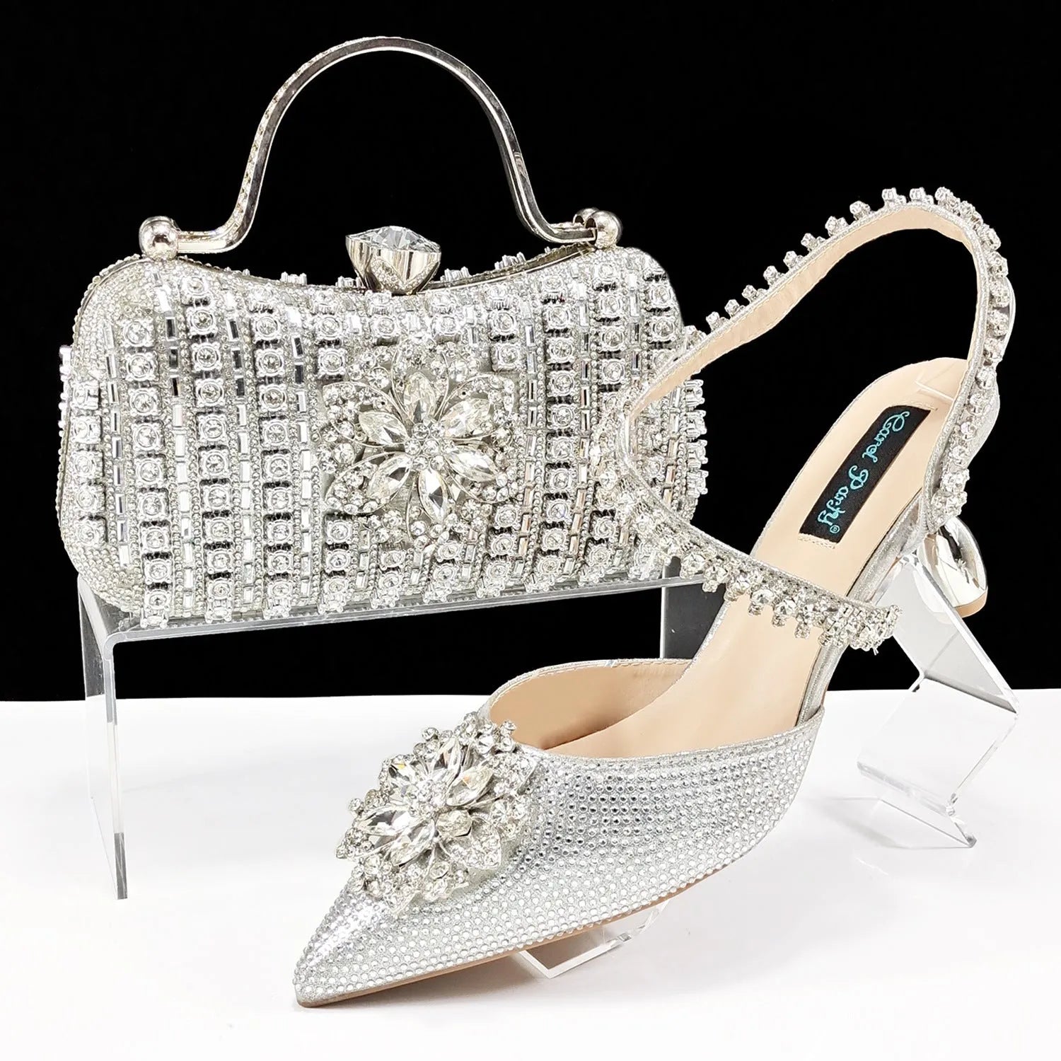 Women's high heel shoes with matching clutch bag featuring decorative flower buckle and ankle chain detail