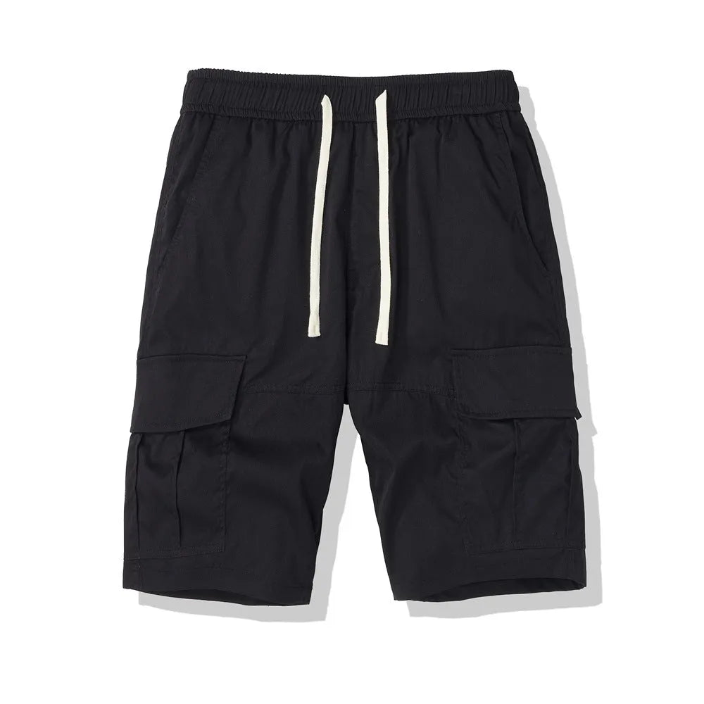 Man wearing loose-fit black cropped trousers with multiple pockets, summer casual style
