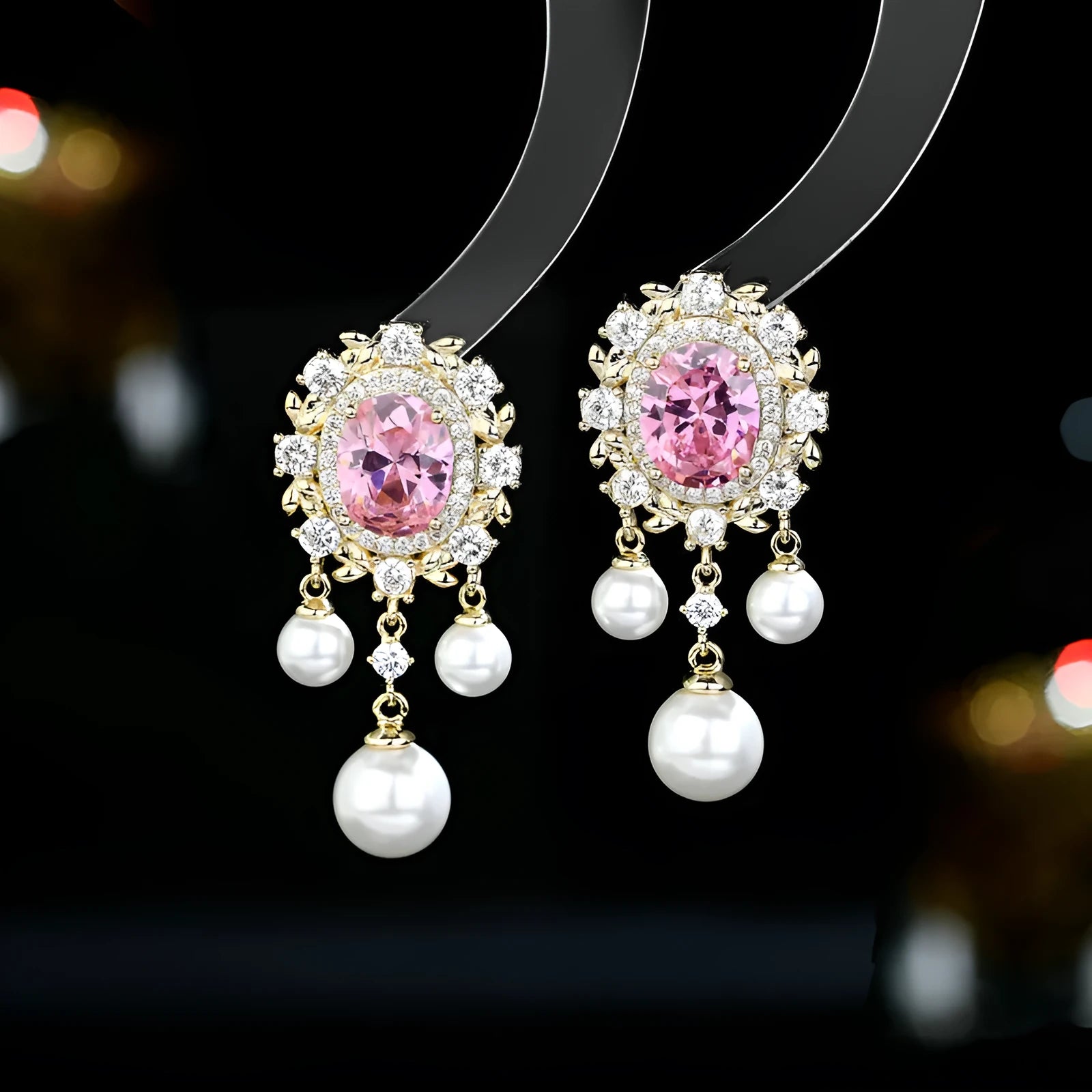 Oval-shaped geometric drop earring with a pearl tassel and inlaid zircon crystals in light purple.