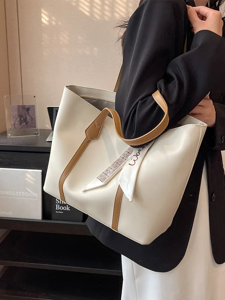 Women's soft large tote bag in a chosen colour, showing outer pockets and sewing detail.