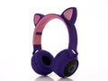 Cartoon-style pink wireless Bluetooth headset with cat ears on headband
