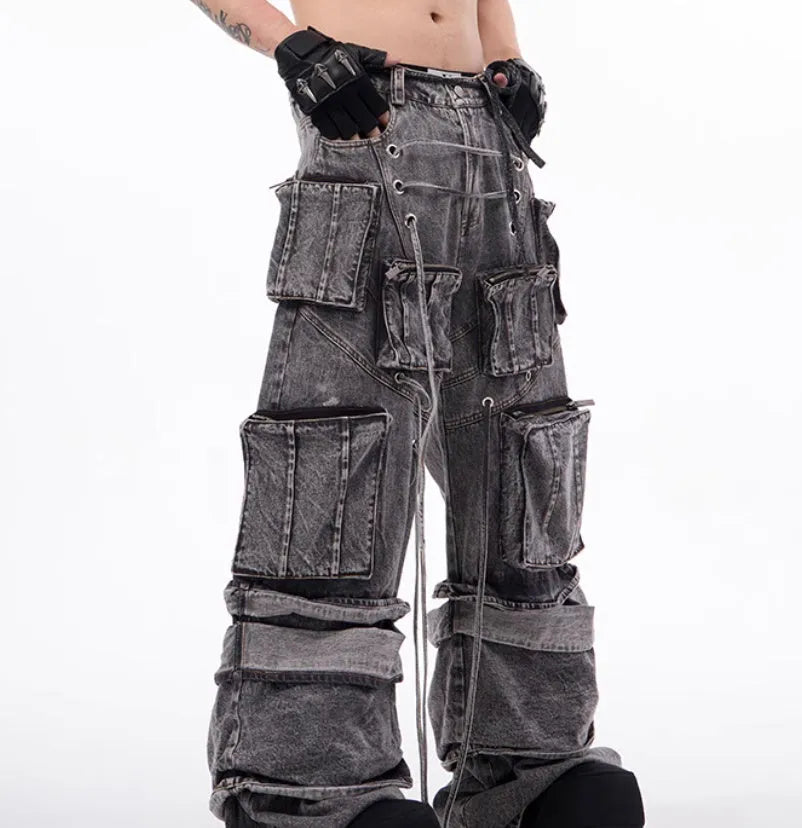 Grey distressed denim overalls for men with rope stitching on the legs and a mop pant cut.