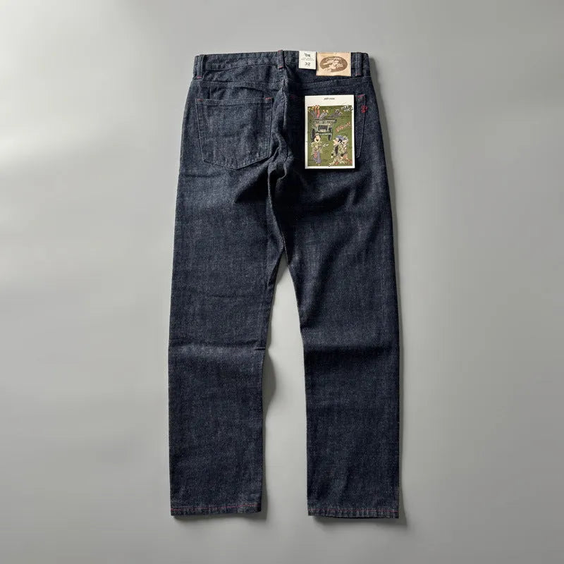 Men's straight leg denim trousers in a primary blue wash, showing front view on a hanger.