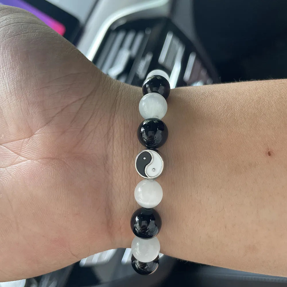 Close-up of a 10mm natural opal and black agate beaded Tai Chi bracelet for men and women.