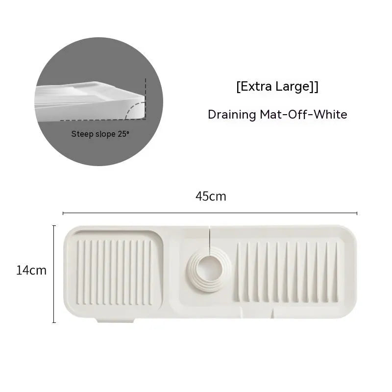 Silicone faucet pad with sloped design under a kitchen tap, showing drainage channels.