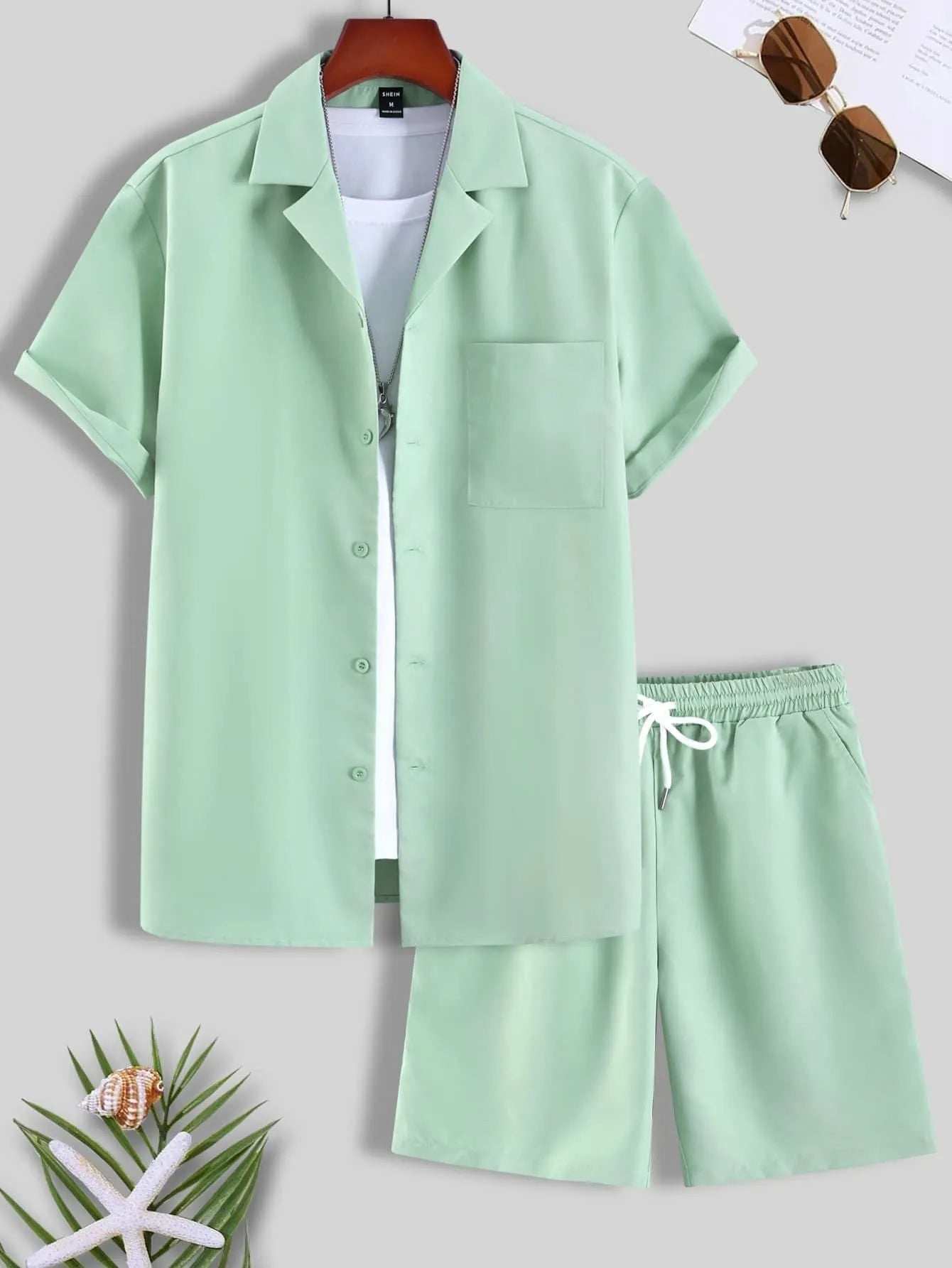 Men's white short sleeve Cuban collar sport shirt and matching shorts laid flat.