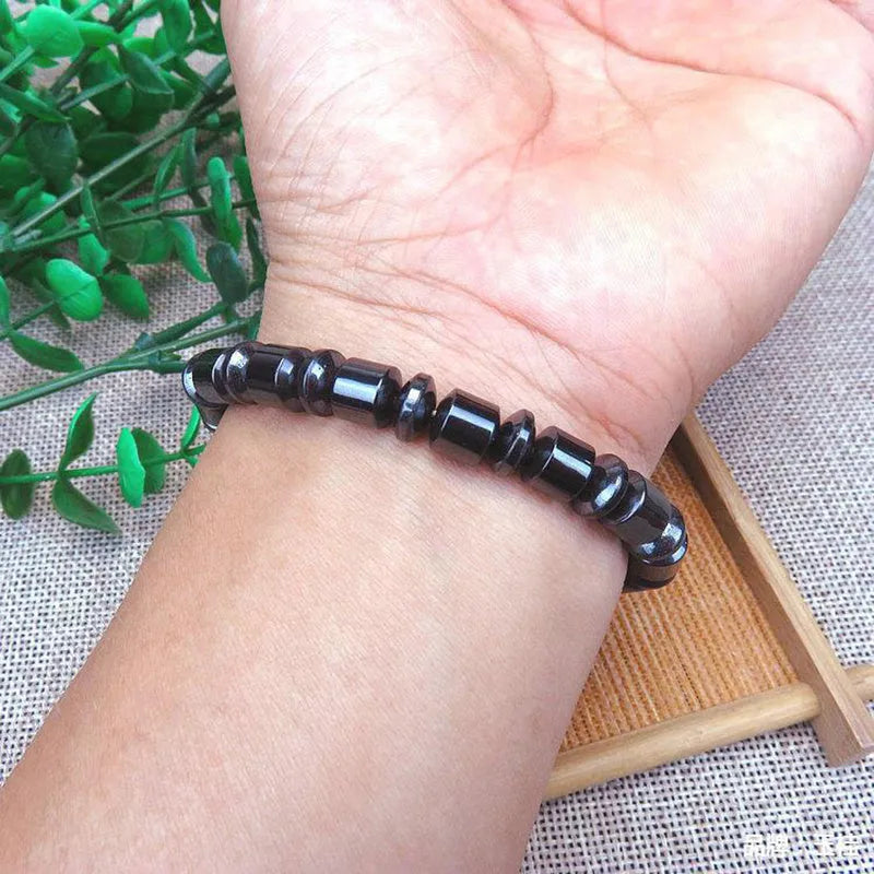 Black pentagram magnetic therapy bracelet made from magnetite and hematite stones with a stretch fit.