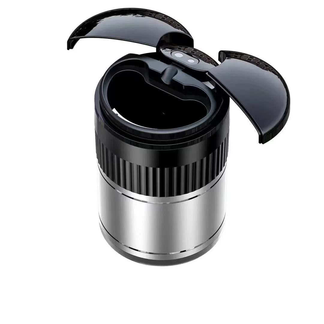 Black automatic infrared sensing metal car ashtray with lid on a car dashboard.