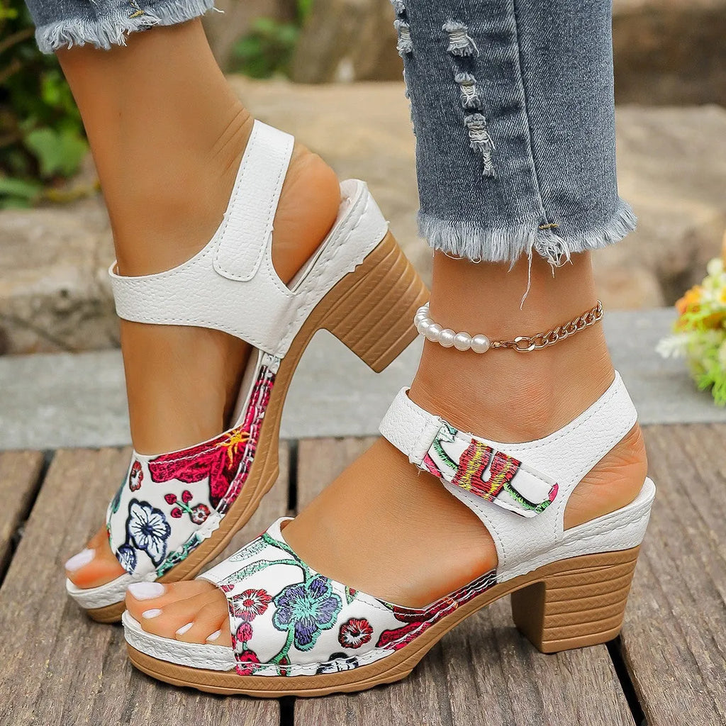 White women's casual high heel sandals with a prominent Velcro strap buckle closure.