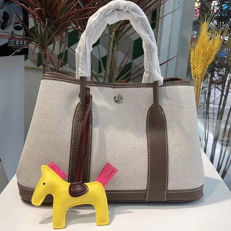 Genuine leather women's crossbody tote bag with canvas texture in bucket shape