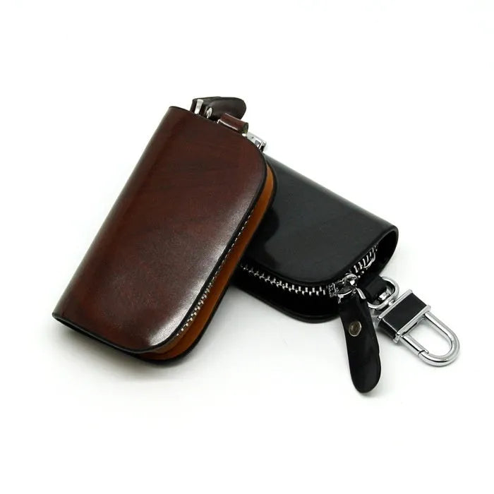 Genuine leather car key case with zipper in black and brown frosted finish.