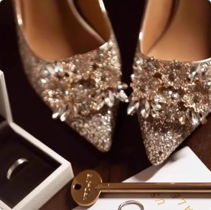 Champagne pointed toe wedding shoes with crystal rhinestone detail on a fine high heel.