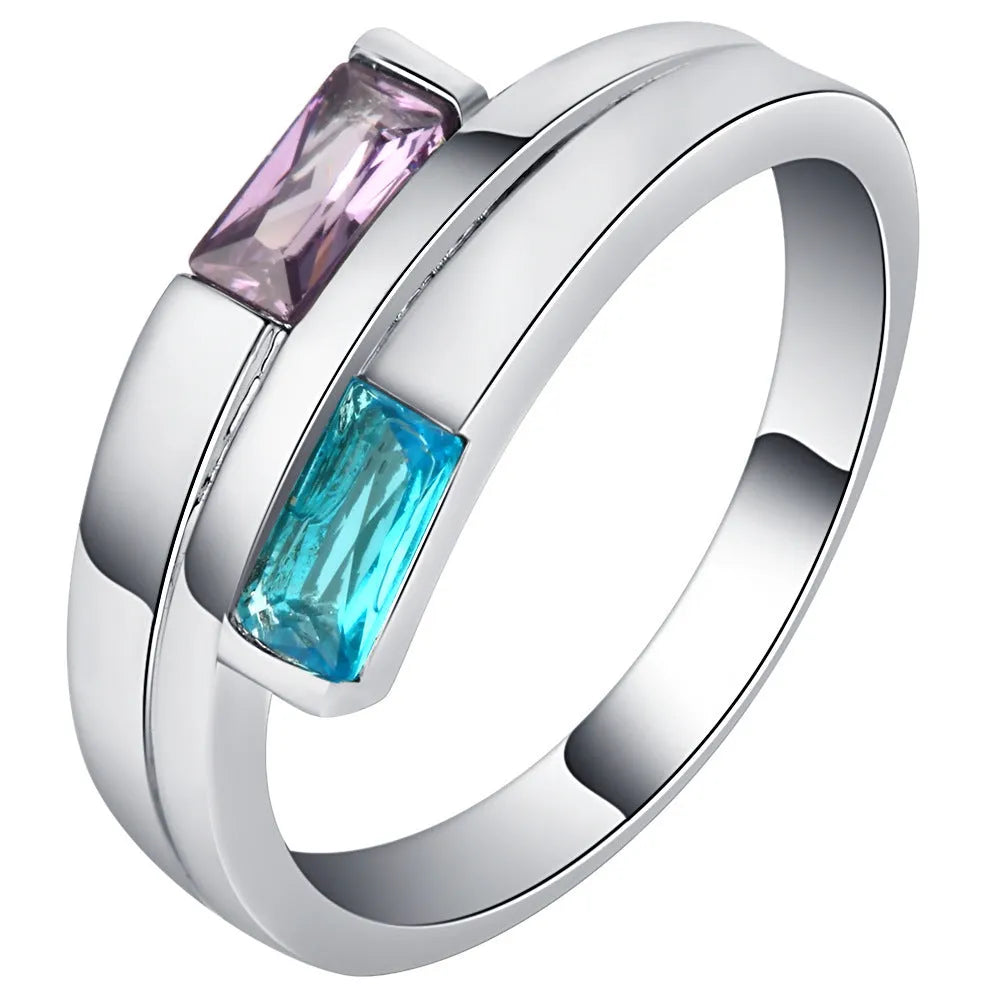 Silver colour copper electroplated ring with inlaid zircon stone on a band